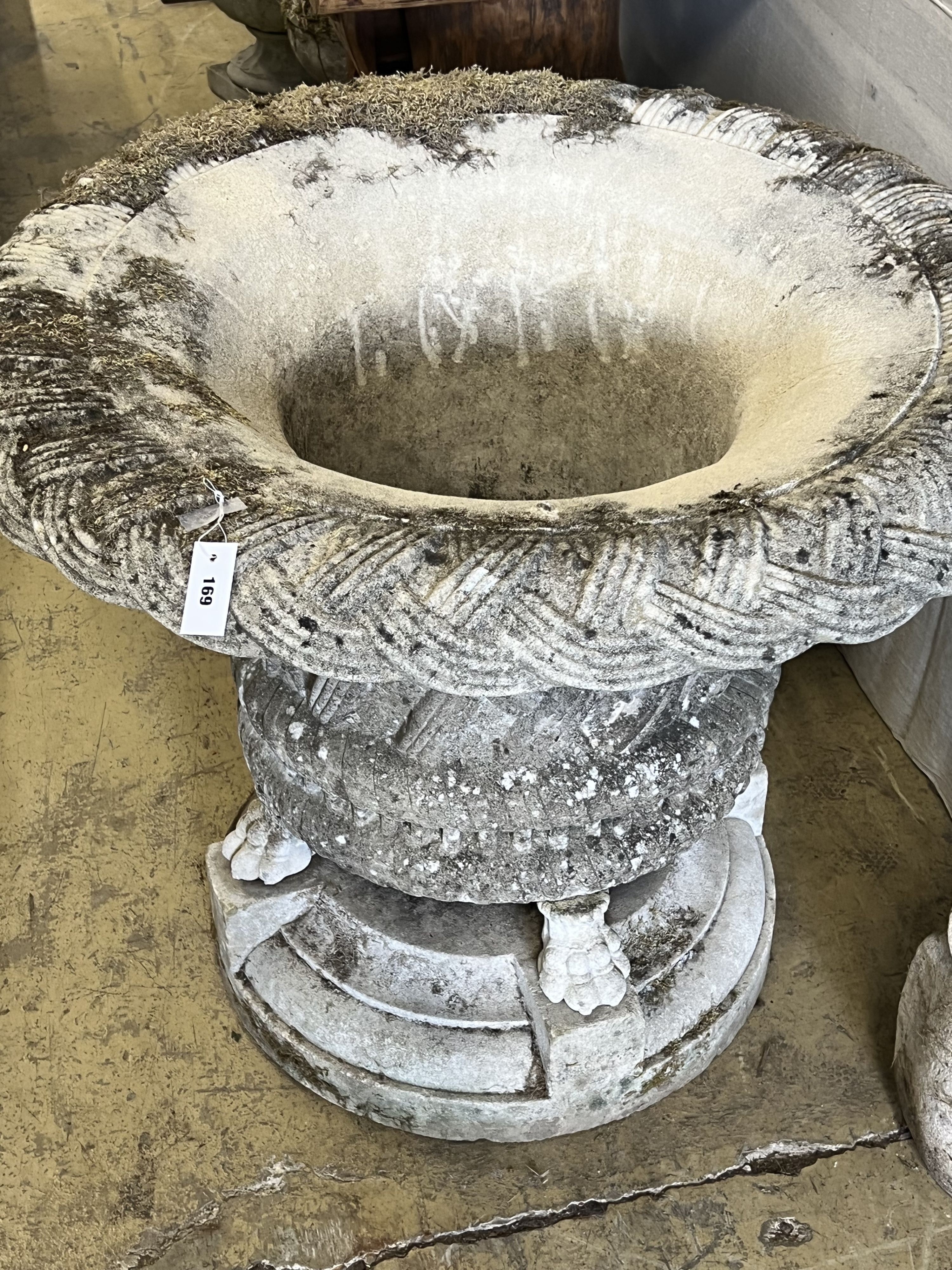 A large reconstituted stone basketweave garden urn on lions paw feet, diameter 104cm height 86cm